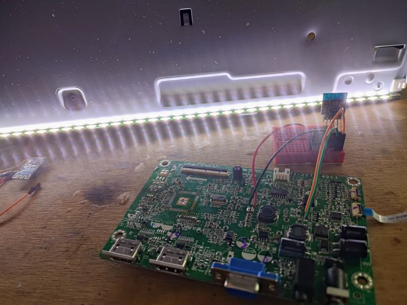 PCB Board with Connected LED Strip PCB board and illuminated LED strip on a table