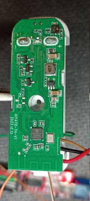 Circuit board of a temperature-humidity sensor with electronic components on a green background.