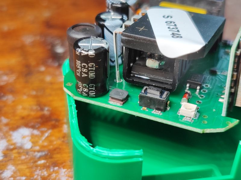 Interior of DIW-01 Dimmer View of the interior of a dimmer with visible electronic components on a green PCB.