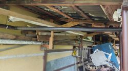 Storage of building materials under a shelter.