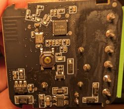 Close-up of a PCB with AU5101XA chip and various surface-mount components.
