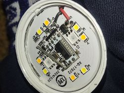 Close-up of the inside of an LED bulb with visible diodes and electronic components on a circuit board.
