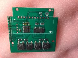 Printed circuit board with electronic components on a pink background.