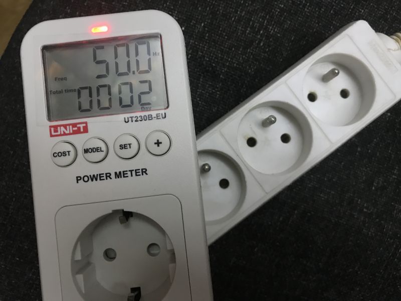 Watyomierz elektroniczny UNI-T UT230B-EU podłączony do listwy zasilającej.