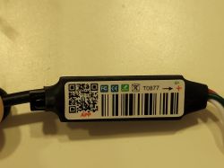 LED controller module with QR code and markings on a white label.