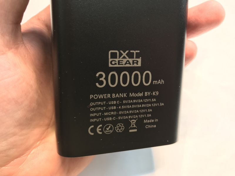NXT Gear BY-K9 30000 mAh power bank with technical specs on the casing