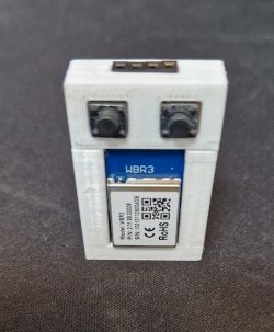 Small device with buttons and a WBR3 module inside white 3D-printed enclosure