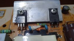 Close-up of electronic components on a circuit board, including FQPF20N60C transistors.