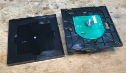 Interior of SmartLED 8044 Light Switch with Exposed PCB Open SmartLED 8044 light switch case with PCB and touch coil visible inside.