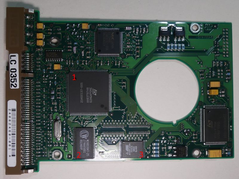 Hard drive circuit board with marked integrated circuits.