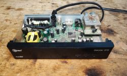Interior of DVB Decoder with Electronic Components Interior of a DVB decoder with visible mainboard, power supply, and capacitors.
