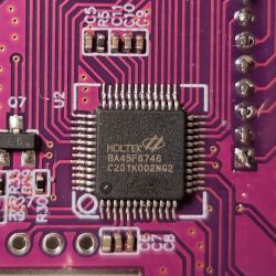 Close-up of a 48-pin Holtek BA45F6746 chip on a circuit board.