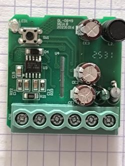 Close-up of a PCB with BL0942 chip, capacitors, and screw terminal block