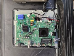 Interior of electronic device with visible mainboard and various connectors