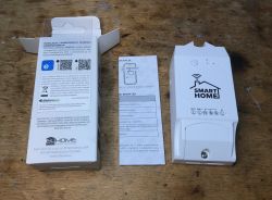 WS-05H1 Controller with Packaging and Instructions WS-05H1 controller lying on a table next to packaging and instructions.