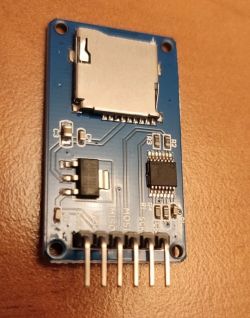 SD Card Reader Module on Circuit Board SD card reader module on a blue circuit board with visible connectors.