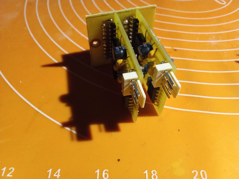 Two yellow electronic modules with USB connectors on an orange background with white circles.