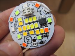 Round Printed Circuit Board with LEDs Colorful LEDs on a round printed circuit board held in hand.