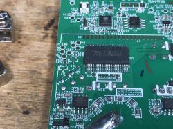 Close-up of a circuit board with integrated circuits and TM1621 marking.