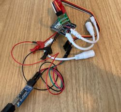 Wired LED Controller with CB3S/BK7231N Module and Probe Clips LED controller board with attached wires and probe clips, lying on a wooden surface.