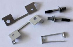 Metal components and potentiometers on a white background.