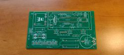 A circuit board for a time programmer with components labeled on a green laminate.