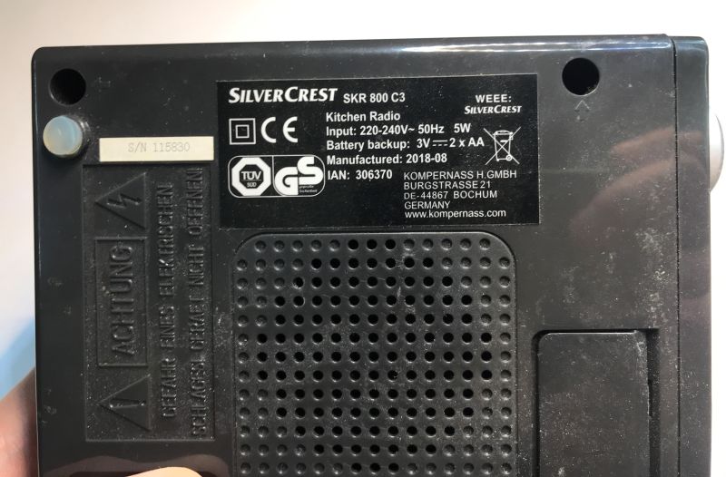 Bottom of a black SilverCrest SKR 800 C3 kitchen radio with rating label and speaker grille