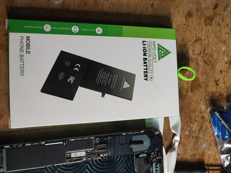 iPhone Battery Replacement Kit Lithium-ion battery replacement kit with a phone missing its battery.