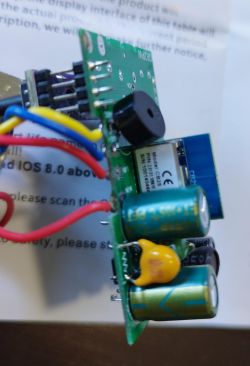 Electronic circuit board with mounted components and connected wires.