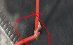 Damaged red wire with visible break