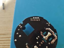 Smart Plug Printed Circuit Board Close-up of a smart plug's printed circuit board with visible solder contacts.