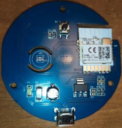 Image of a round PCB with various electronic components including a Wi-Fi module and connectors.
