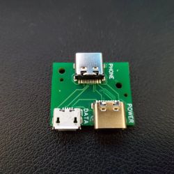 Green circuit board with three ports: USB Type C, Micro USB, and a full-size USB.