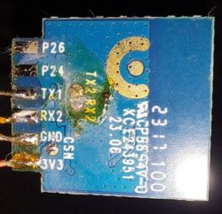 Close-up of an electronic module with visible pins and labels.