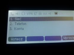 Wyświetlacz telefonu pokazujący menu z opcjami: Sieć, Telefon i Konta.