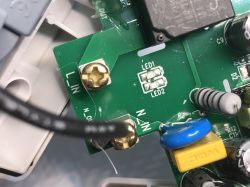 Close-up of the ATLO-S1IP5-TUYA socket’s PCB showing L_IN and N_IN labels, two screws, and visible electronic components.