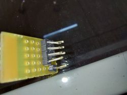 Close-up of a board with bent pins for solder-free testing.