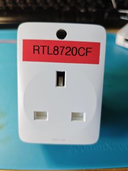 White electrical plug with a red label RTL8720CF.