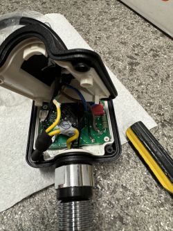Interior of a WiFi thermostat for an electric towel radiator with visible wires and electronic components.