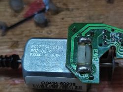 DC Motor with Circuit Board DC motor with a circuit board on a workbench.