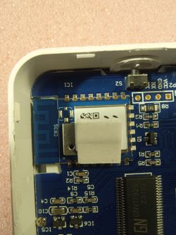 Close-up of the interior of an electronic device with visible components and markings.