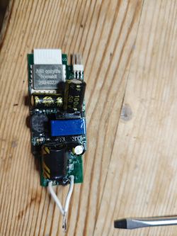Cozylife Homekit A60 Module Cozylife Homekit A60 module with visible capacitors and components on a wooden background
