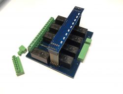 Relay board with green screw terminals and a blue panel.
