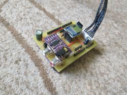 ESP32-based radio module assembled on a PCB with electronic components and connected wires.