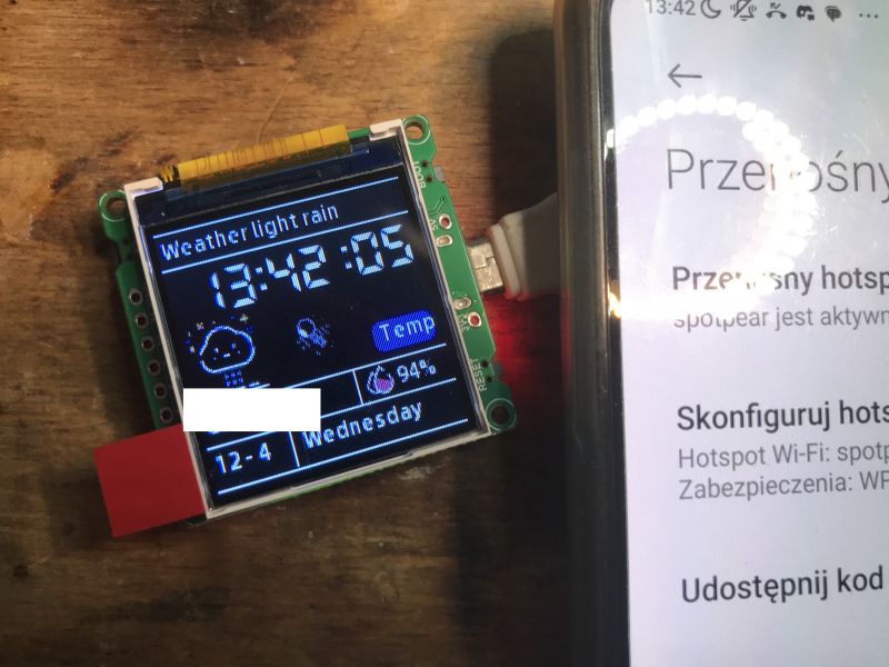 ESP32 C3 with LCD Display and Smartphone with Hotspot ESP32 C3 display showing weather data next to a smartphone with hotspot settings.