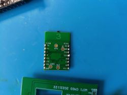 Green PCB module with labeled pins including PIN9, TX, RX, IO1, IO2, IO3, GND, 3V3, PIN13, BTN, ADC, EN1, EN2, IO0, and GND.