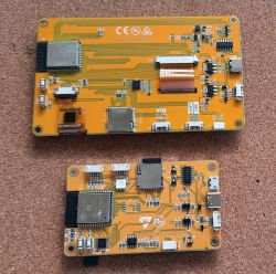 Two electronic modules with yellow circuit boards, a larger one on top and a smaller one at the bottom.