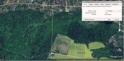 Satelitarne zdjęcie terenu z lasami, polami i osiedlami mieszkaniowymi, z narzędziem pomiaru odległości w Google Earth.