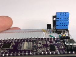DHT11 sensor module and DS18B20 thermometer on a breadboard.