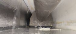 Interior of a fireplace with visible smoke exhaust pipe.